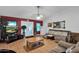 Living room featuring brown sofas, wood floors, and a view into the kitchen at 3401 N Dakota St, Chandler, AZ 85225