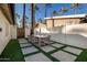 Outdoor patio with table, chairs, and artificial turf, perfect for dining al fresco at 4311 E Roma Ave, Phoenix, AZ 85018
