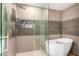 Bathroom features a walk-in shower and a free-standing tub at 4311 E Roma Ave, Phoenix, AZ 85018