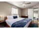 Bedroom with a king bed, access to another room, and wood floors at 4311 E Roma Ave, Phoenix, AZ 85018