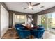 Modern dining room with a large wooden table and blue velvet chairs at 4311 E Roma Ave, Phoenix, AZ 85018