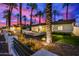 Stunning curb appeal at night; single-story home with palm trees and modern landscaping at 4311 E Roma Ave, Phoenix, AZ 85018