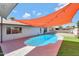 Inviting kidney-shaped pool with shade sail in backyard at 4832 W Caron St, Glendale, AZ 85302
