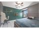 Bedroom with teal walls, queen bed, and built in shelves at 4832 W Caron St, Glendale, AZ 85302