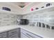 Kitchen corner with white cabinets, white countertops, and a microwave at 4832 W Caron St, Glendale, AZ 85302