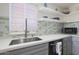 Modern kitchen features gray cabinets, white countertops, and a stylish tile backsplash at 4832 W Caron St, Glendale, AZ 85302