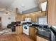 Open concept kitchen with granite counters, wood cabinets, and island at 523 S Jaspar Dr, Apache Junction, AZ 85119
