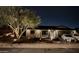 Single-story home with nighttime exterior lighting and rock landscaping at 5535 W Crocus Dr, Glendale, AZ 85306