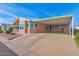 Tan manufactured home with carport and easy access at 8500 E Southern Ave # 548, Mesa, AZ 85209