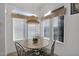 Charming kitchen breakfast nook with three chairs and a window view at 8500 E Southern Ave # 548, Mesa, AZ 85209