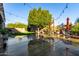 Relaxing backyard oasis with lush landscaping, patio furniture, and string lights at 11957 N 140Th Ln, Surprise, AZ 85379