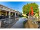 Large backyard with covered patio, string lights, and artificial turf at 11957 N 140Th Ln, Surprise, AZ 85379