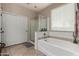 Elegant bathroom with soaking tub and separate shower at 11957 N 140Th Ln, Surprise, AZ 85379