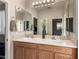 Double sink bathroom vanity with wood cabinets and large mirror at 11957 N 140Th Ln, Surprise, AZ 85379