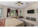 Bright Primary bedroom featuring a large TV and comfortable seating at 11957 N 140Th Ln, Surprise, AZ 85379