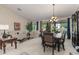 Spacious dining area with large windows and chandelier at 11957 N 140Th Ln, Surprise, AZ 85379