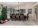 Bright dining area with a Christmas tree and large windows at 11957 N 140Th Ln, Surprise, AZ 85379