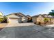 Two-story house with three-car garage and desert landscaping at 11957 N 140Th Ln, Surprise, AZ 85379