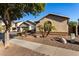 One-story house with two-car garage and desert landscaping with palm trees at 11957 N 140Th Ln, Surprise, AZ 85379