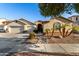 Tan two-story house with three-car garage, landscaping, and palm trees at 11957 N 140Th Ln, Surprise, AZ 85379