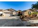 Two-story house with three-car garage and desert landscaping at 11957 N 140Th Ln, Surprise, AZ 85379
