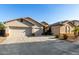 Two-story house with three-car garage and desert landscaping at 11957 N 140Th Ln, Surprise, AZ 85379