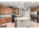 Kitchen with curved island and stainless steel fridge at 11957 N 140Th Ln, Surprise, AZ 85379