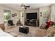 Bright living room featuring a fireplace and large TV at 11957 N 140Th Ln, Surprise, AZ 85379
