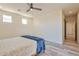 Bright bedroom with ceiling fan, wood-look floors, and access to a walk-in closet at 1278 W Calle Tuberia --, Casa Grande, AZ 85194