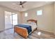 Bedroom with sliding glass door to patio, ceiling fan and wood-look floors at 1278 W Calle Tuberia --, Casa Grande, AZ 85194