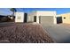 Modern stucco home with two-car garage and desert landscaping at 1298 W Calle Tuberia --, Casa Grande, AZ 85194