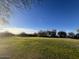 Green grass golf course with trees in the background at 1298 W Calle Tuberia --, Casa Grande, AZ 85194