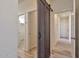 Long hallway with barn door, leading to other rooms at 1298 W Calle Tuberia --, Casa Grande, AZ 85194