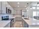 Modern kitchen with gray cabinets, stainless steel appliances, and an island at 1298 W Calle Tuberia --, Casa Grande, AZ 85194