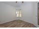 Simple bedroom with wood-look floors and large window at 3061 N Platina Cir # N, Mesa, AZ 85215