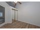 Bedroom with mirrored closet doors and wood-look floors at 3061 N Platina Cir # N, Mesa, AZ 85215