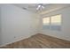 Well-lit bedroom with wood-look floors and window at 3061 N Platina Cir # N, Mesa, AZ 85215