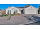 White one-story house with solar panels, a two-car garage, and a landscaped front yard at 3061 N Platina Cir # N, Mesa, AZ 85215