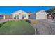 One-story home with artificial turf, stone pathway, and a wooden fence at 3061 N Platina Cir # N, Mesa, AZ 85215