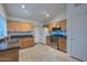 Kitchen with light wood cabinets, granite countertops, and stainless steel appliances at 3061 N Platina Cir # N, Mesa, AZ 85215