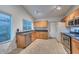 Kitchen with light wood cabinets, granite countertops, and stainless steel appliances at 3061 N Platina Cir # N, Mesa, AZ 85215
