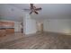 Spacious living room with wood-look tile floors and a ceiling fan at 3061 N Platina Cir # N, Mesa, AZ 85215