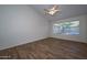 Main bedroom with wood-look floors and large window at 3061 N Platina Cir # N, Mesa, AZ 85215