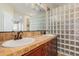 Bathroom with double vanity and glass block shower at 322 E Caribbean Dr, Casa Grande, AZ 85122