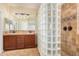 Bathroom with double vanity, glass block shower, and tile flooring at 322 E Caribbean Dr, Casa Grande, AZ 85122