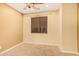 Bedroom with window, ceiling fan and neutral walls at 322 E Caribbean Dr, Casa Grande, AZ 85122