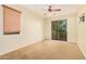 Bedroom with sliding door to balcony and carpet flooring at 322 E Caribbean Dr, Casa Grande, AZ 85122