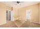 Bright bedroom with carpet flooring, ceiling fan, and ample closet space at 322 E Caribbean Dr, Casa Grande, AZ 85122
