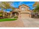 Two-story house with a large front yard, two-car garage, and neutral color scheme at 322 E Caribbean Dr, Casa Grande, AZ 85122