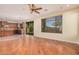 Open living space with hardwood floors, a fireplace, and access to the kitchen at 322 E Caribbean Dr, Casa Grande, AZ 85122